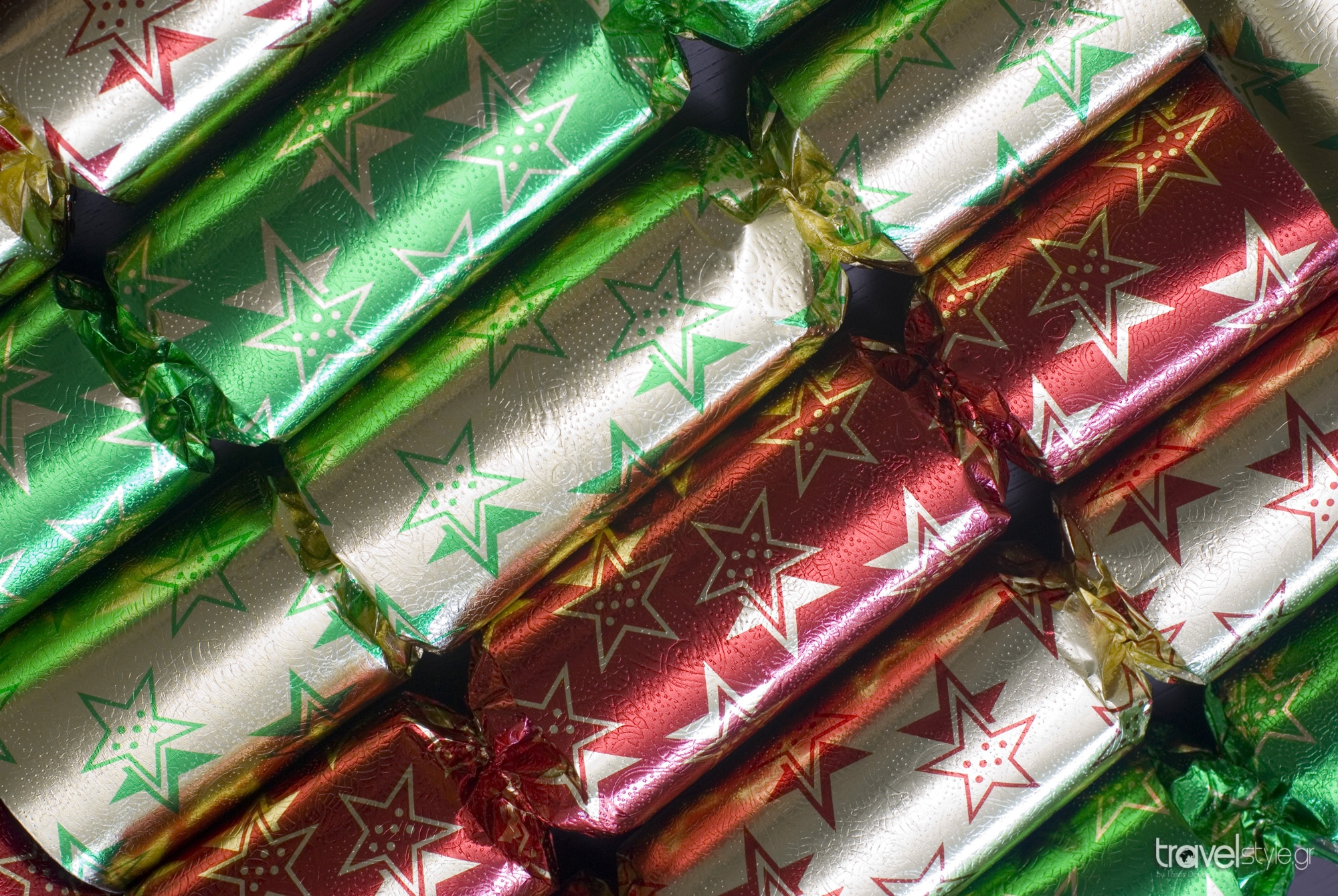 A line of colourful metallic foil christmas crackers