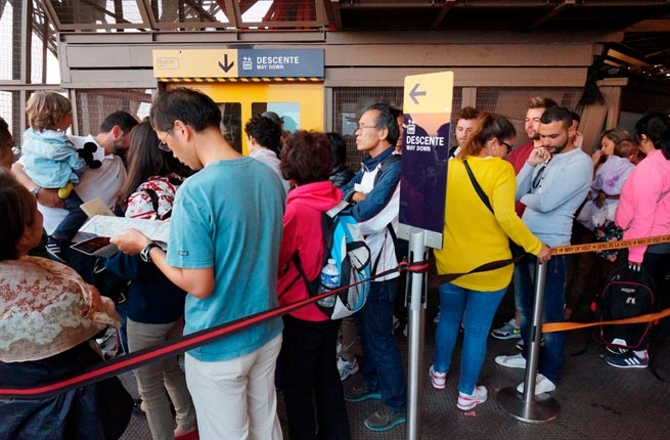 Photo of line for the eiffel tower elevator in france on 9/14/14. These people are waiting to go down.
