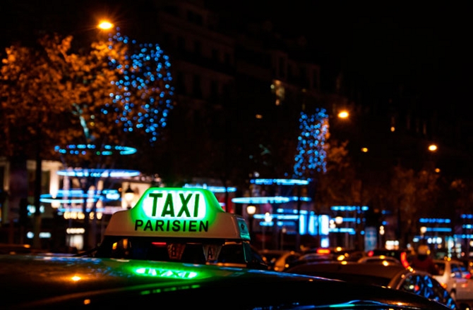 A Parisian taxi for hire at Avenue des Champs-Elysees decorated with Christmas illumination.; Shutterstock ID 167697125; Project/Title: 15 Things Not to Do in Paris; Downloader: Fodor's Travel