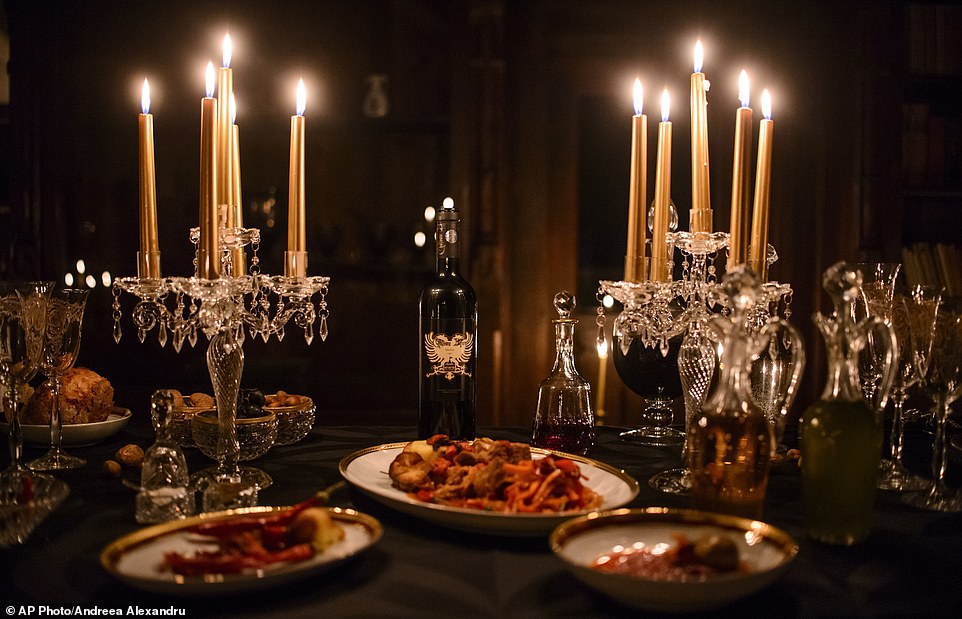 In this picture taken Oct. 9, 2016, a candlelight dinner is set up before a photo shoot, in Bran Castle, in Bran, Romania. Airbnb has launched a contest to find two people to stay overnight in the castle on Halloween, popularly known as Dracula’s castle because of its connection to the cruel real-life prince Vlad the Impaler, who inspired the legend of Dracula. (AP Photo/Andreea Alexandru)