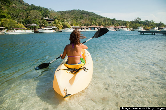 Young woman kayaking in sea