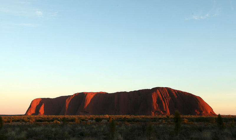 Sunrise show the vibrant red colors of Uluru, Australia, Tuesday, April 22, 2014. The Duke and Duchess of Cambridge are on a three-week tour of Australia and New Zealand, the first official trip overseas with their son, Prince George.(AP Photo/Rob Griffith/Pool)